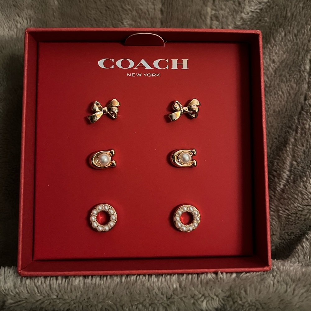 Coach rose gold and pearl bow earrings set.